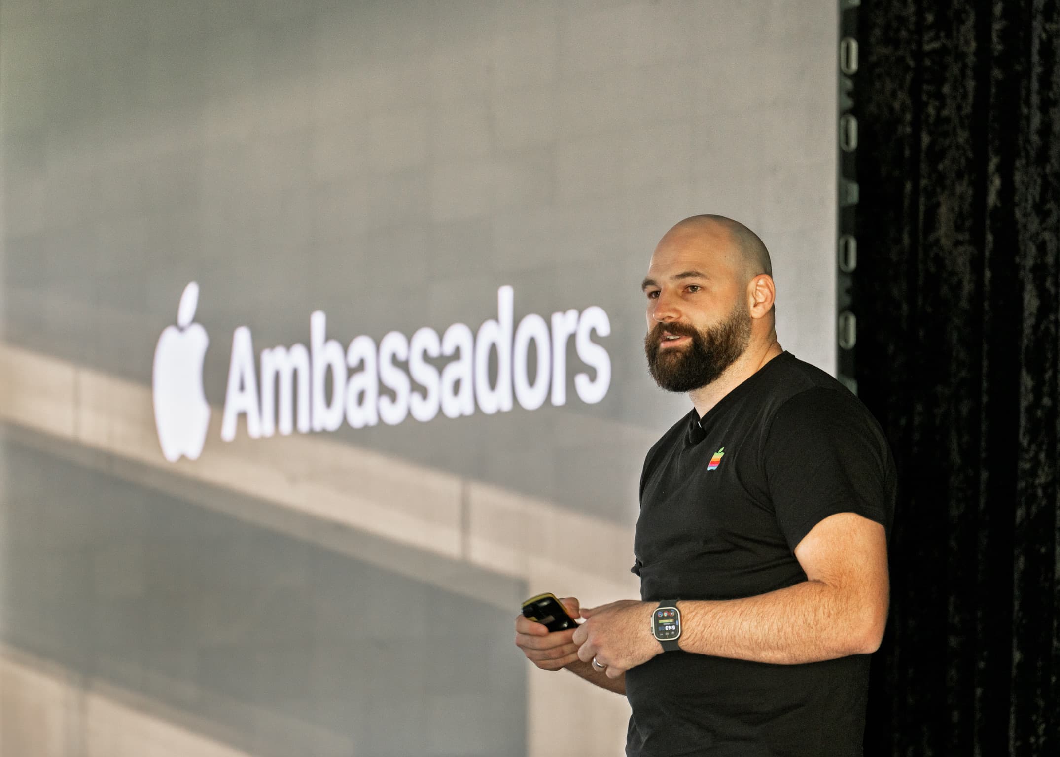Presenter speaking in front of an Apple Ambassadors screen.